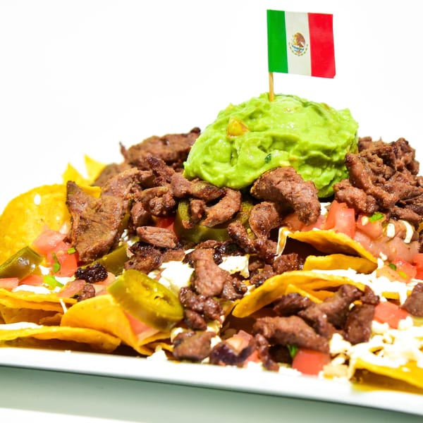 Benji's Taqueria Mexican Grill's nachos with steak, guacamole, jalapeños, and a Mexican flag.