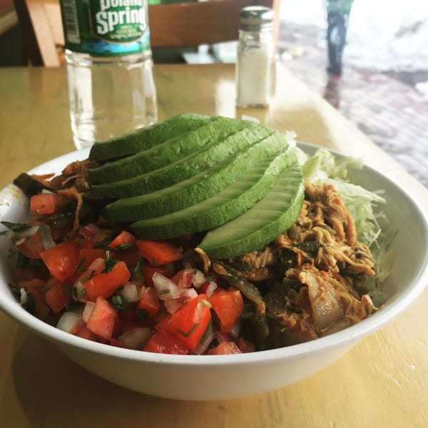 Benji's Taqueria Mexican Grill's burrito bowl with shredded chicken, pico de gallo, avocado, and lettuce.
