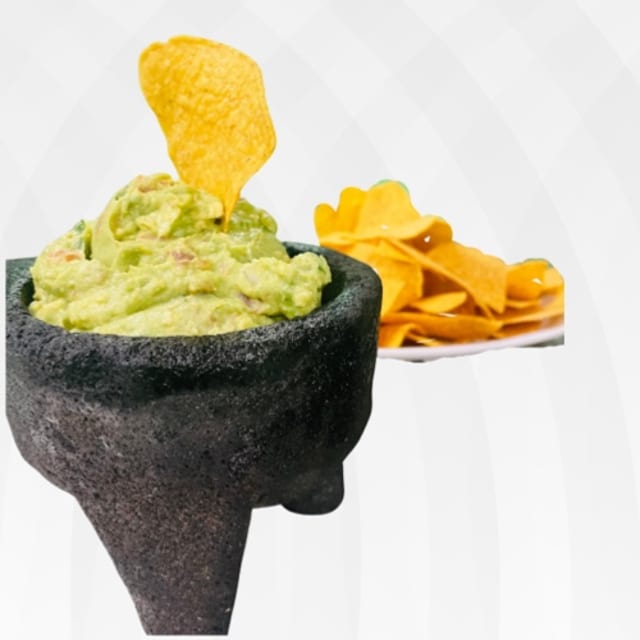Guacamole with homemade corn chips.